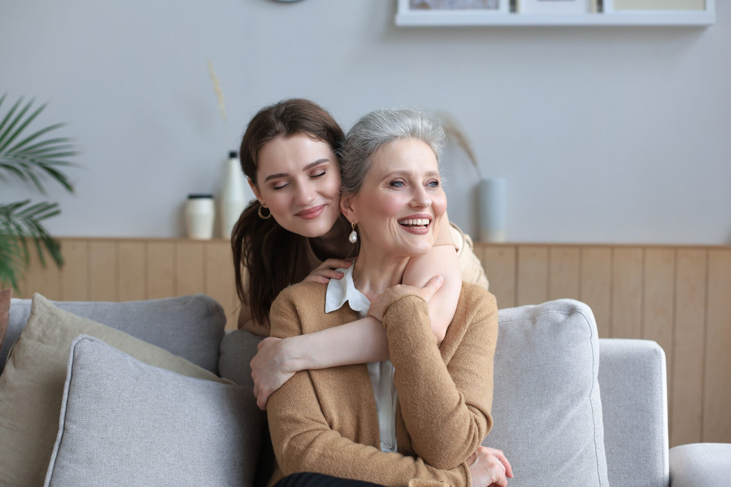 elderly woman and younger daughter hugging in a lincoln nebraska living room